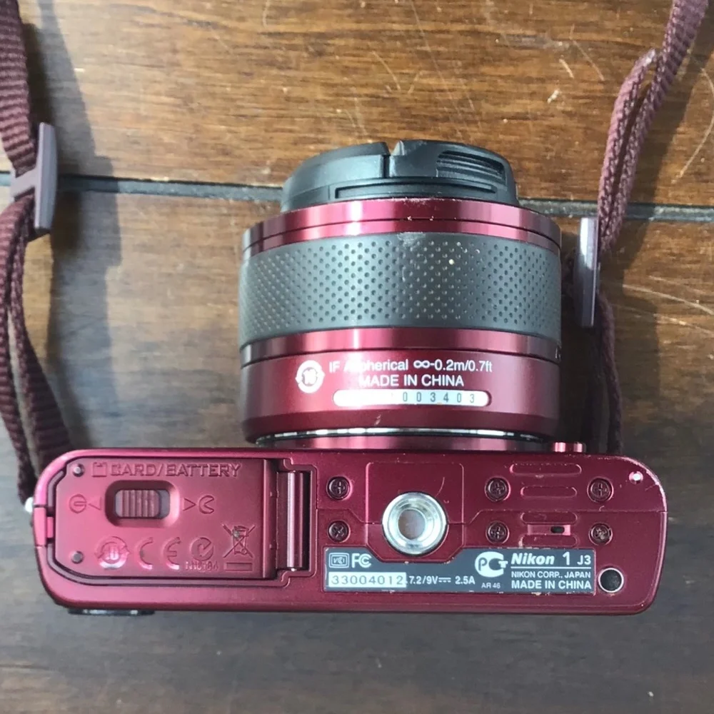 Burgundy Red Nikon 1 J3 high-speed camera with two lenses